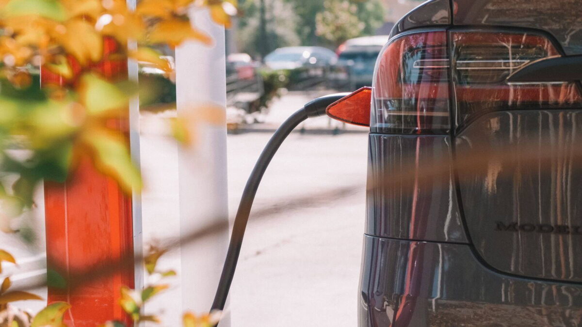 Töltőre csatlakoztatott elektromos autó egy töltőállomáson